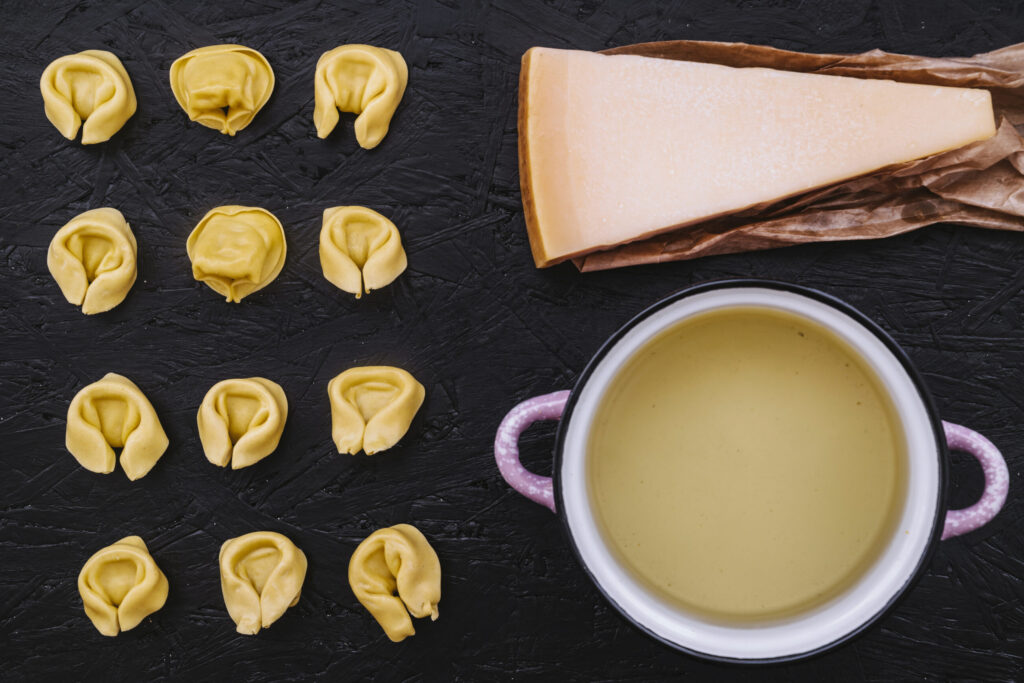 cheese and saucepan near stuffed pasta